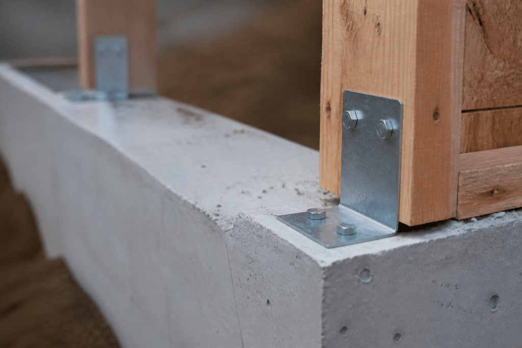 Equerres metalliques fixees sur fondations beton gris