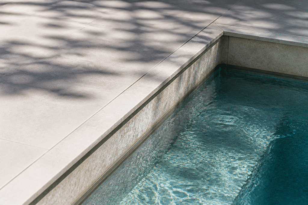 Dalles ciment collees au bord piscine avec mortier exterieur