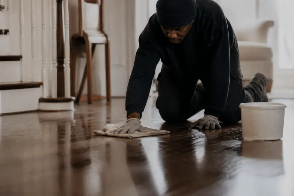 Cloth wiping wet floor with protective finish applied
