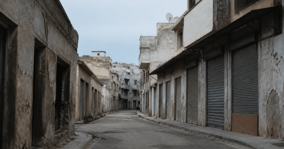 Rue urbaine avec immeubles delabres et commerces fermes